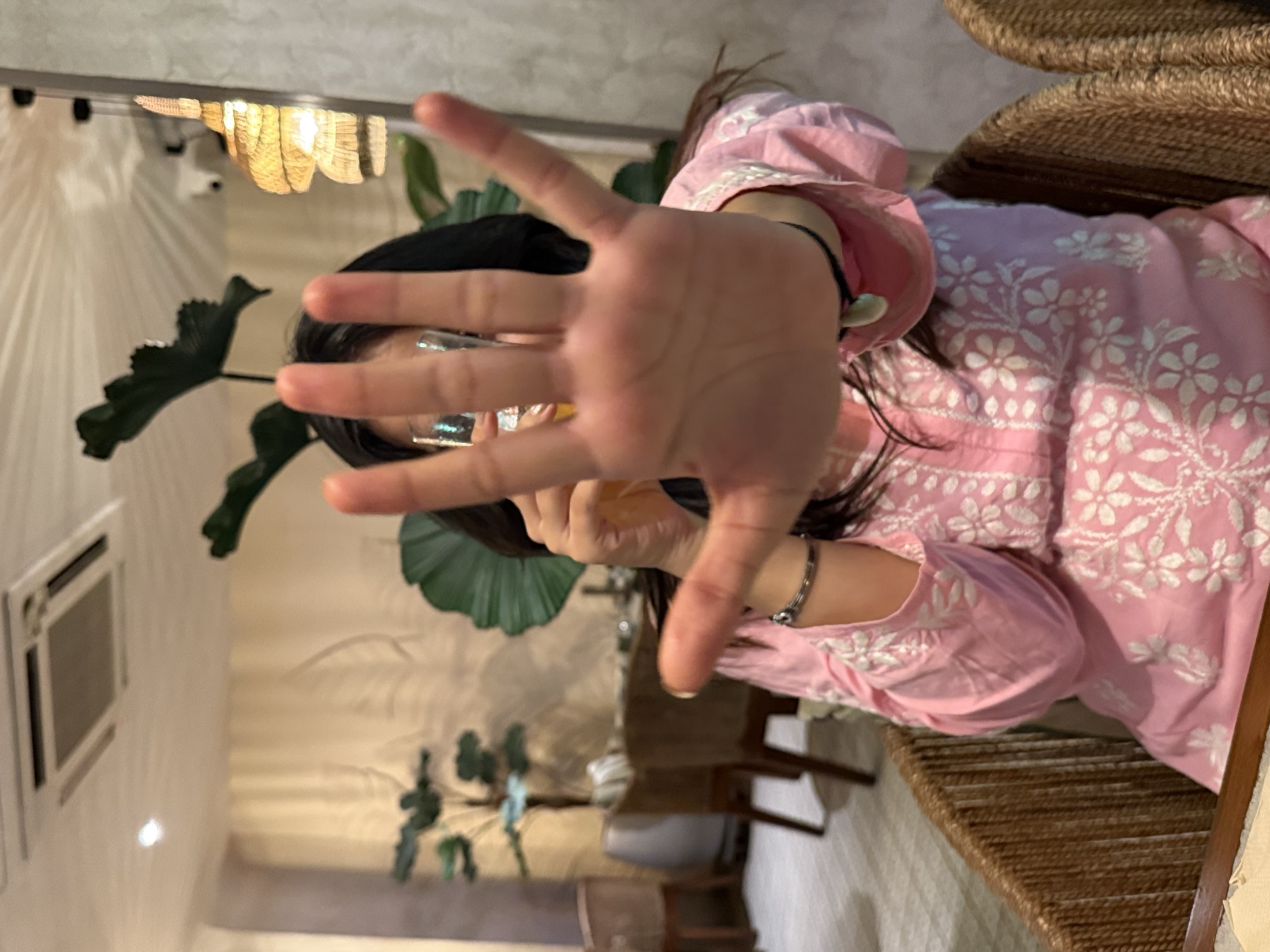 Playful hand covering the face