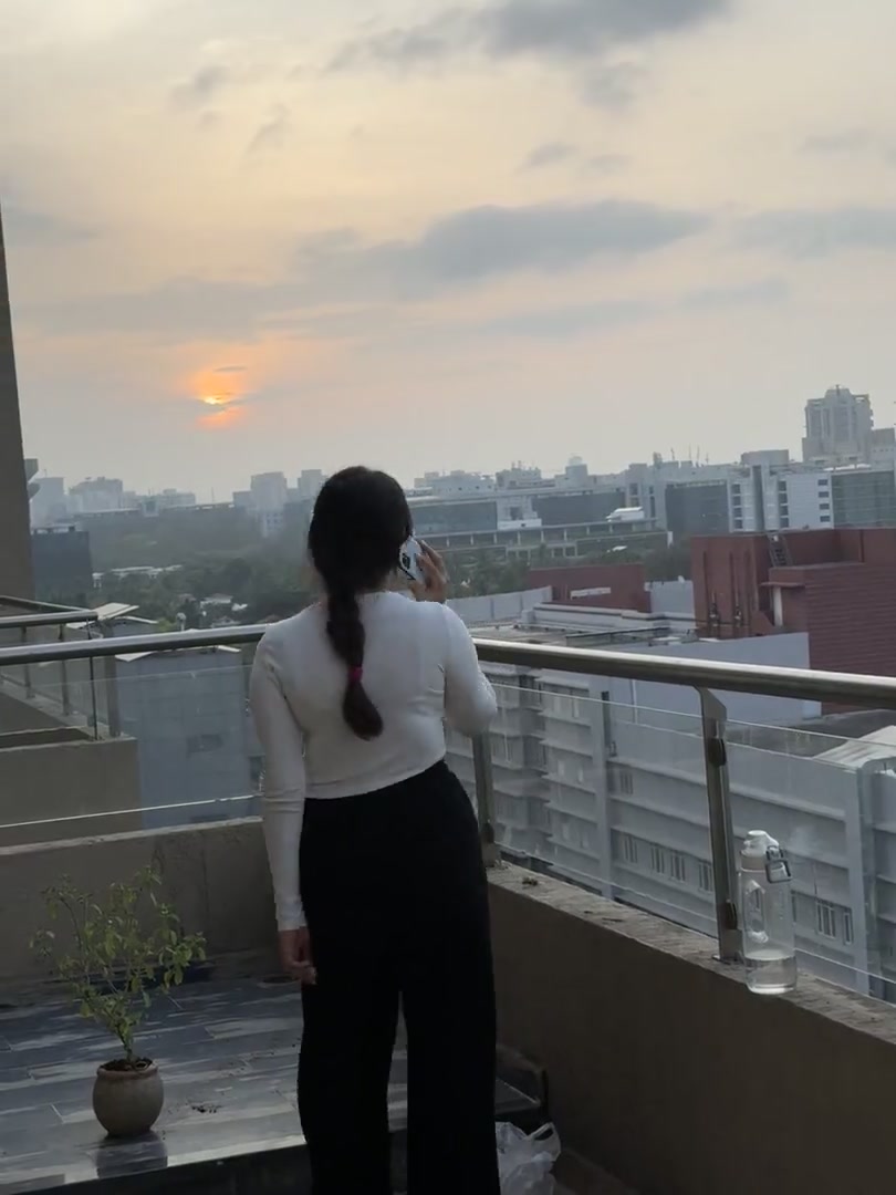 Phone call on a balcony at sunset