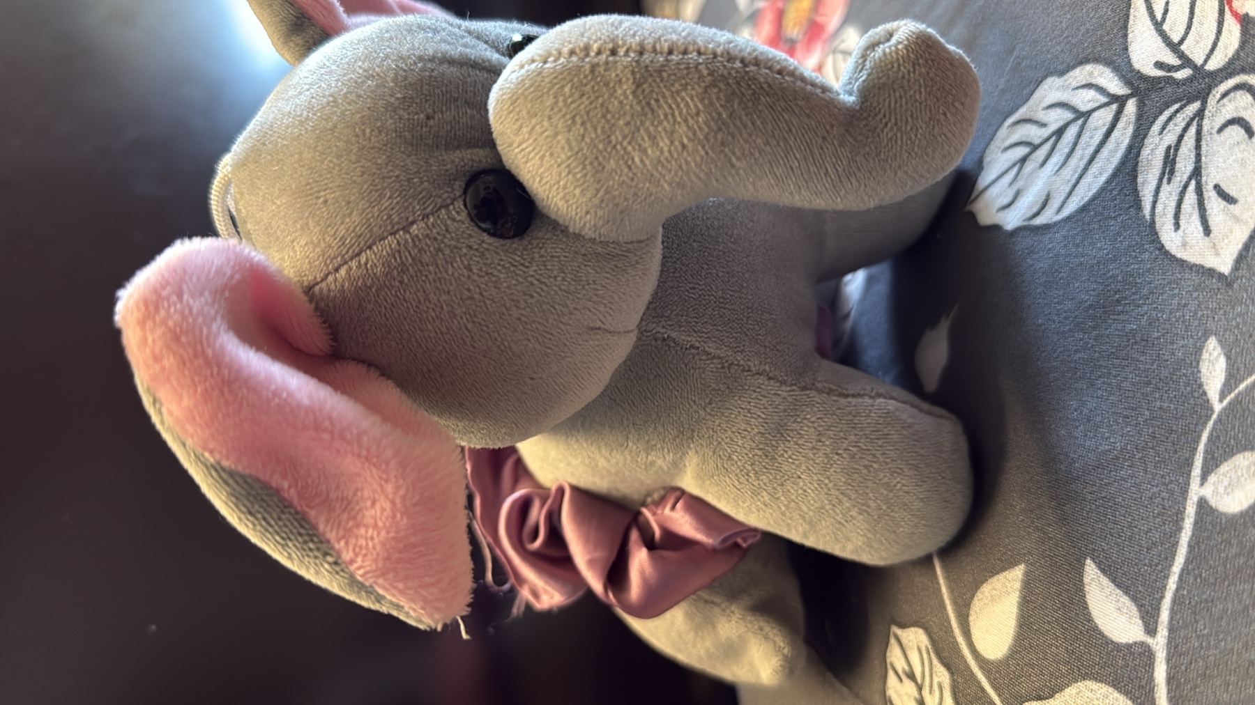 Grey plush elephant with a purple ruffle